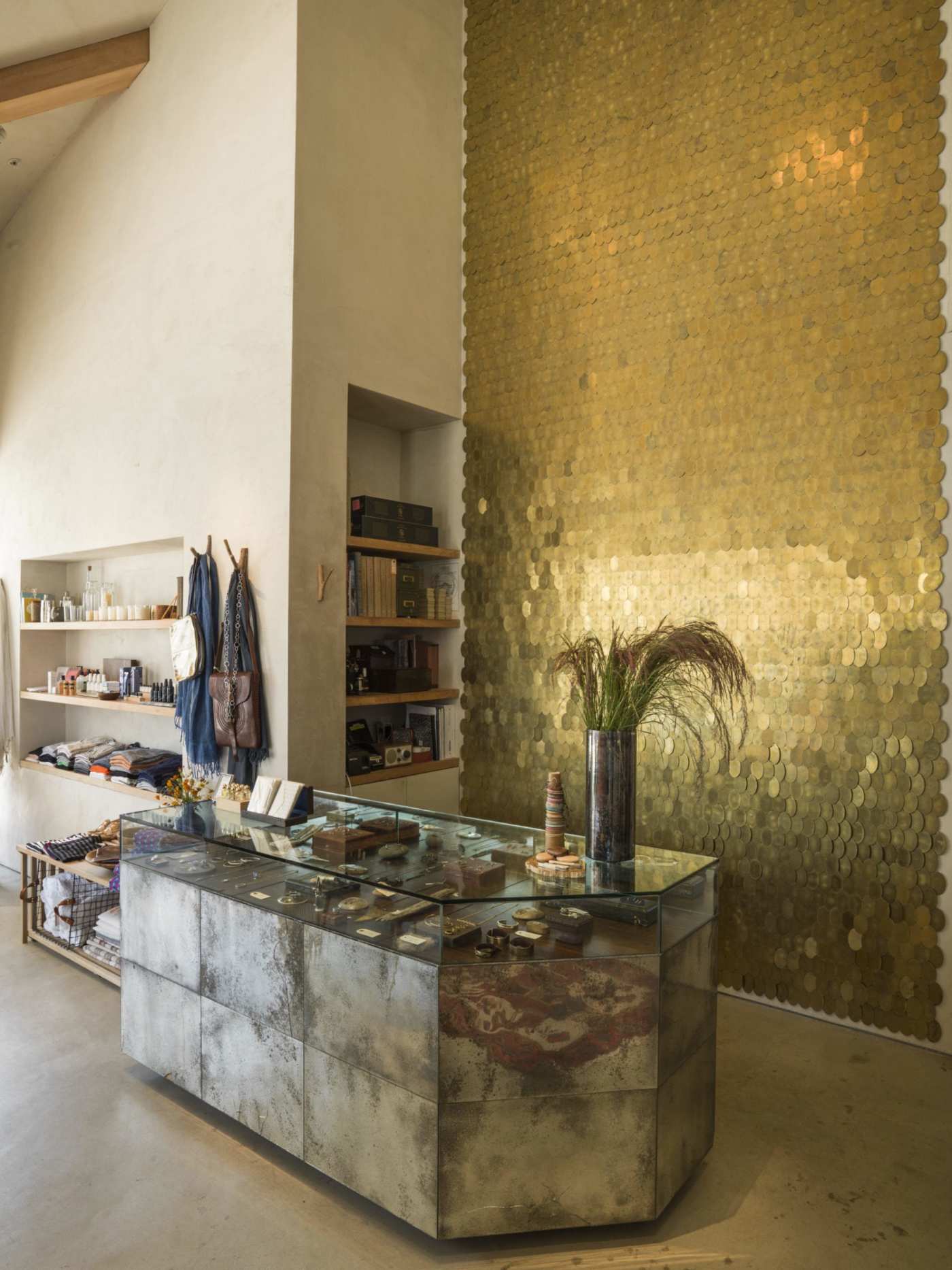 the interior of a store with a gold plated wall.