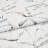 Folded white curtain fabric featuring pale teal and gray watercolor leaf print — folded to show pattern across layers — close-up, evenly lit studio product view.