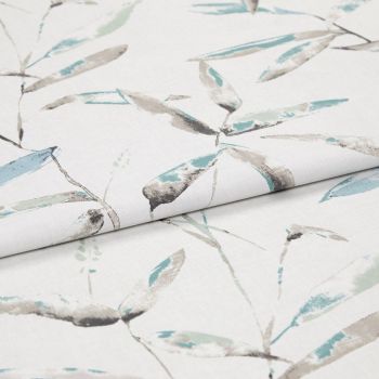 Folded white curtain fabric featuring pale teal and gray watercolor leaf print — folded to show pattern across layers — close-up, evenly lit studio product view.