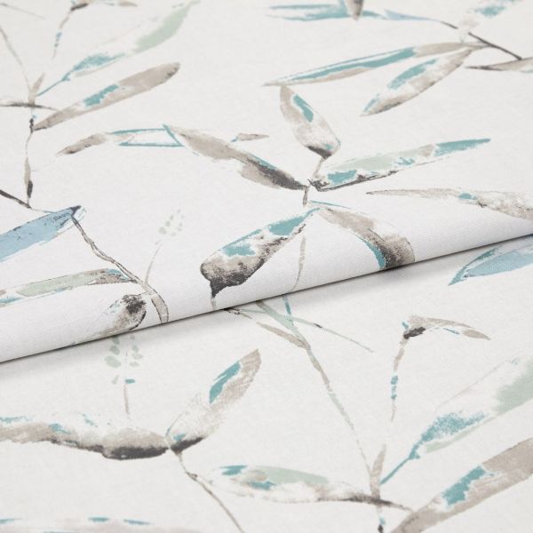 Folded white curtain fabric featuring pale teal and gray watercolor leaf print — folded to show pattern across layers — close-up, evenly lit studio product view.
