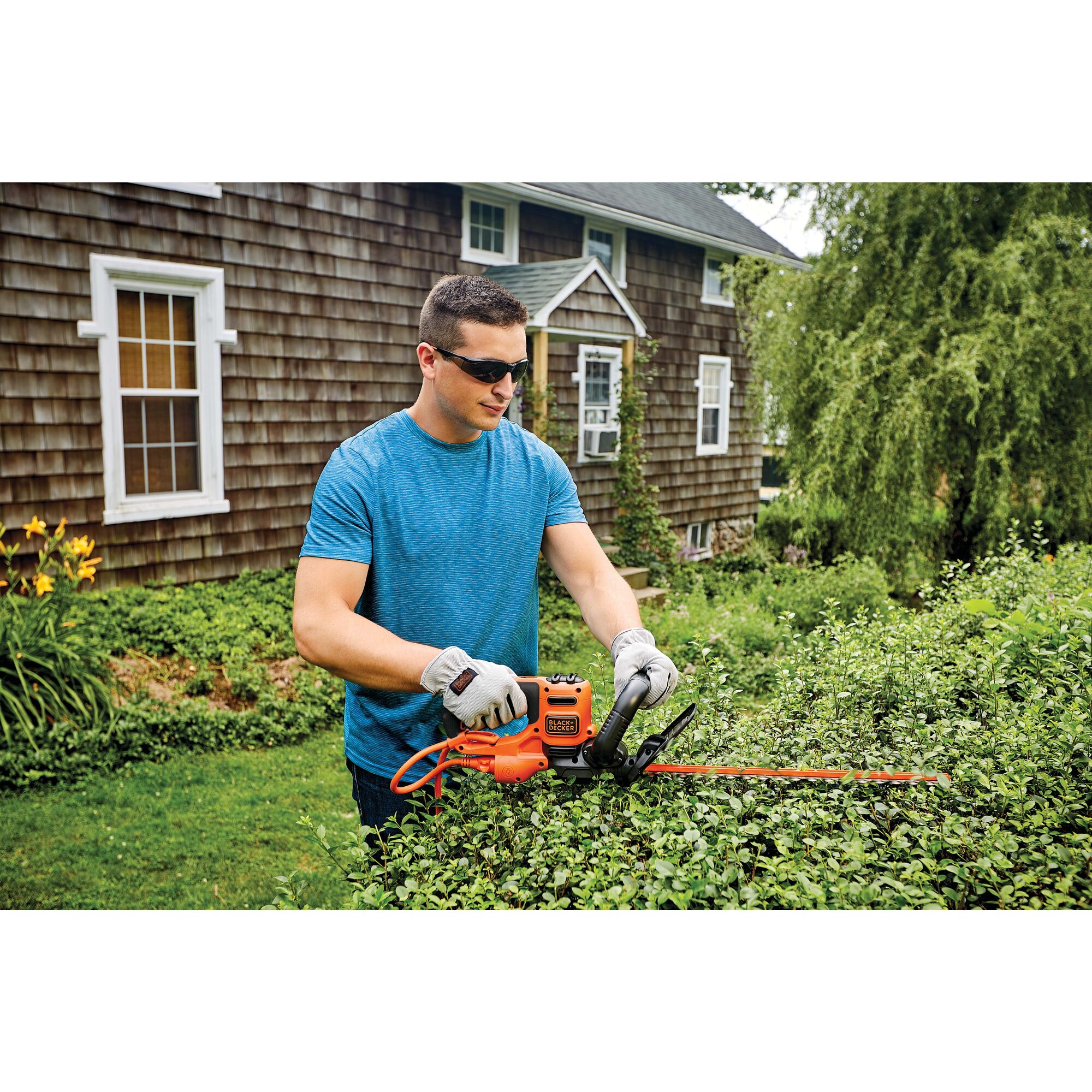 22 inch Electric Hedge Trimmer being used by a person on a hedge.