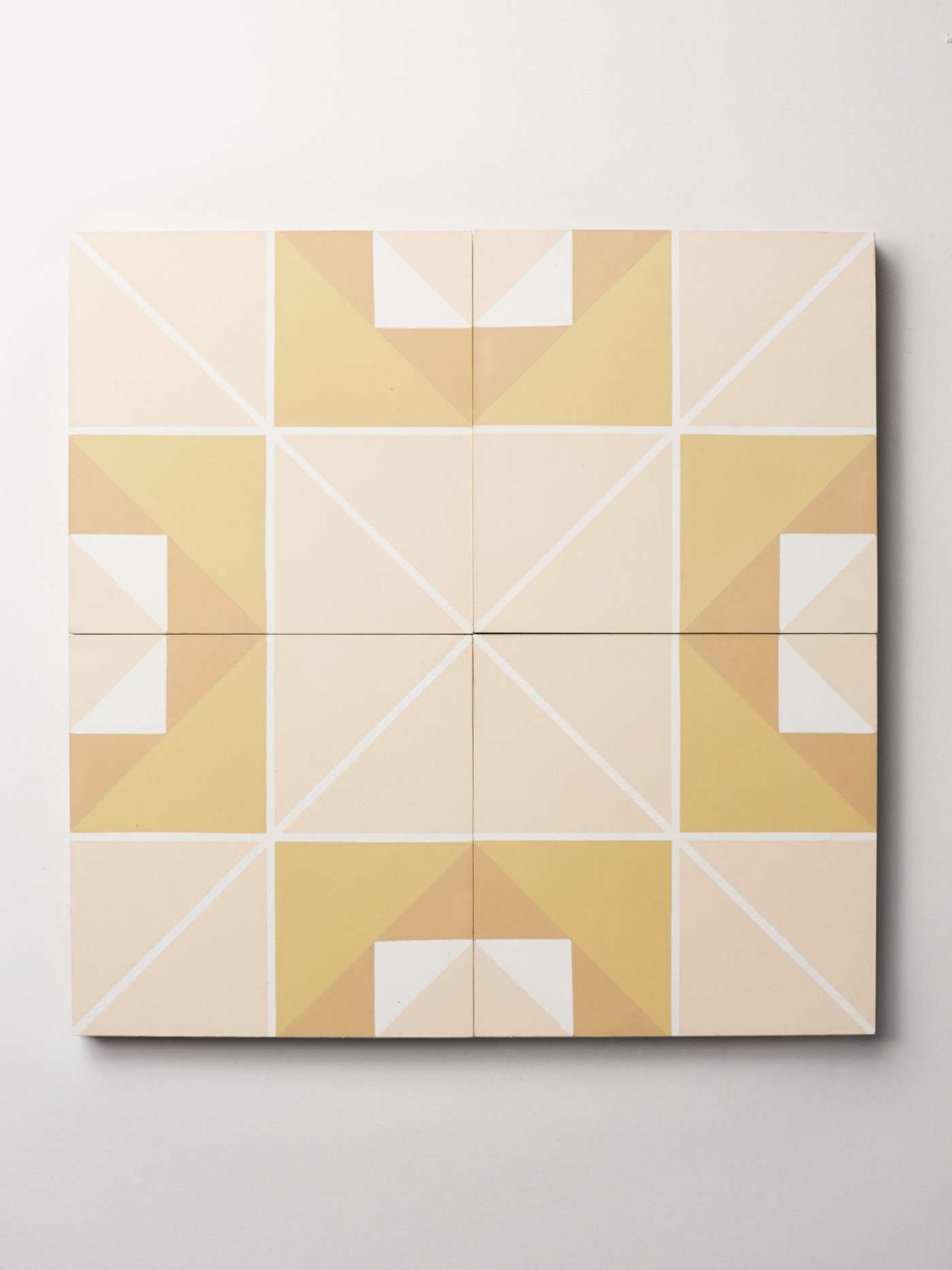 four tiles with yellow and white design on them.