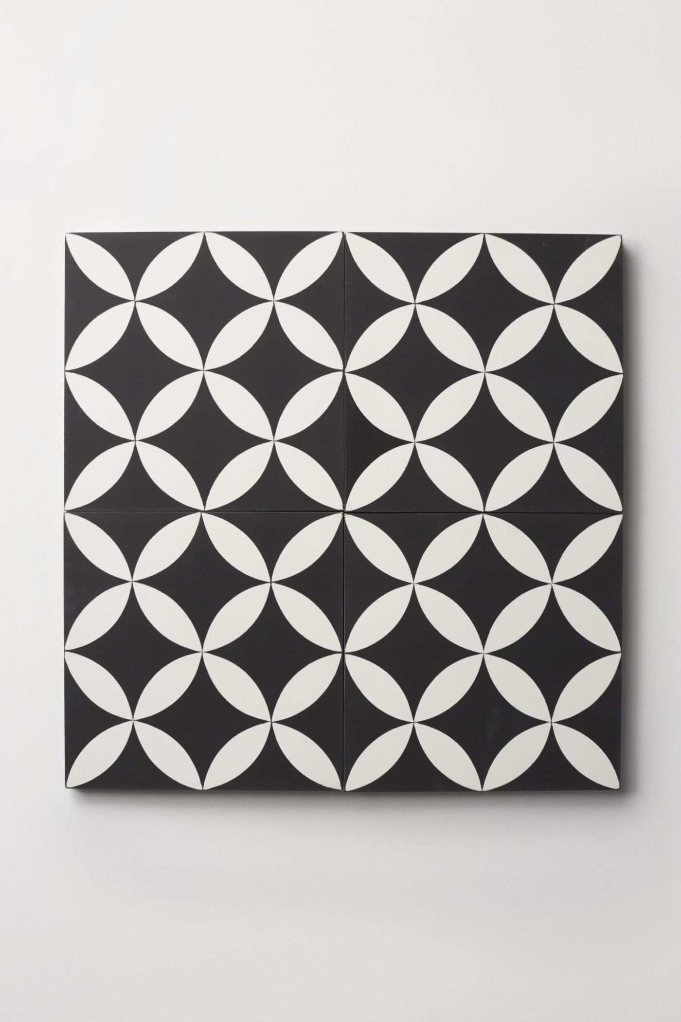 a black and white tile design on a wall.