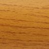 Horizontal-grained light oak wooden surface displaying fine dark streaks; smooth finish reflecting warm even light; close-up view with no surrounding objects or visible edges, emphasizing texture and color.