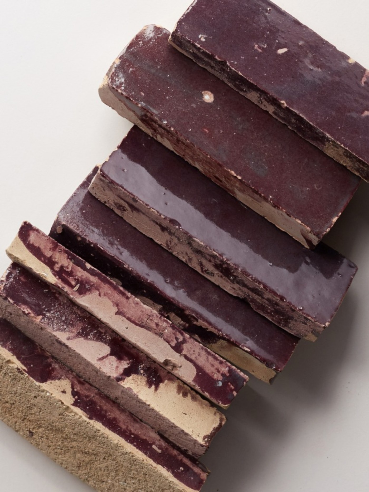 a stack of brown tiles on a white surface.