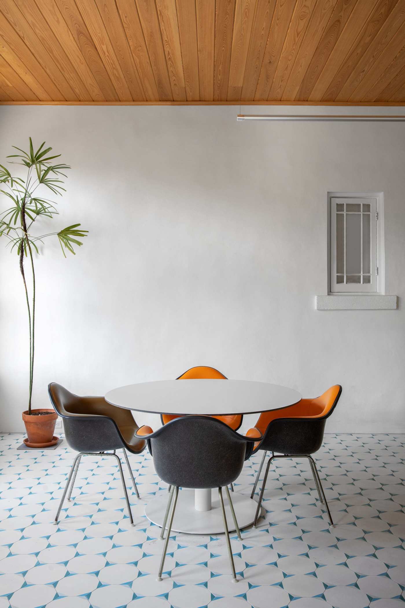 a wooden ceiling in a room with a table and chairs.