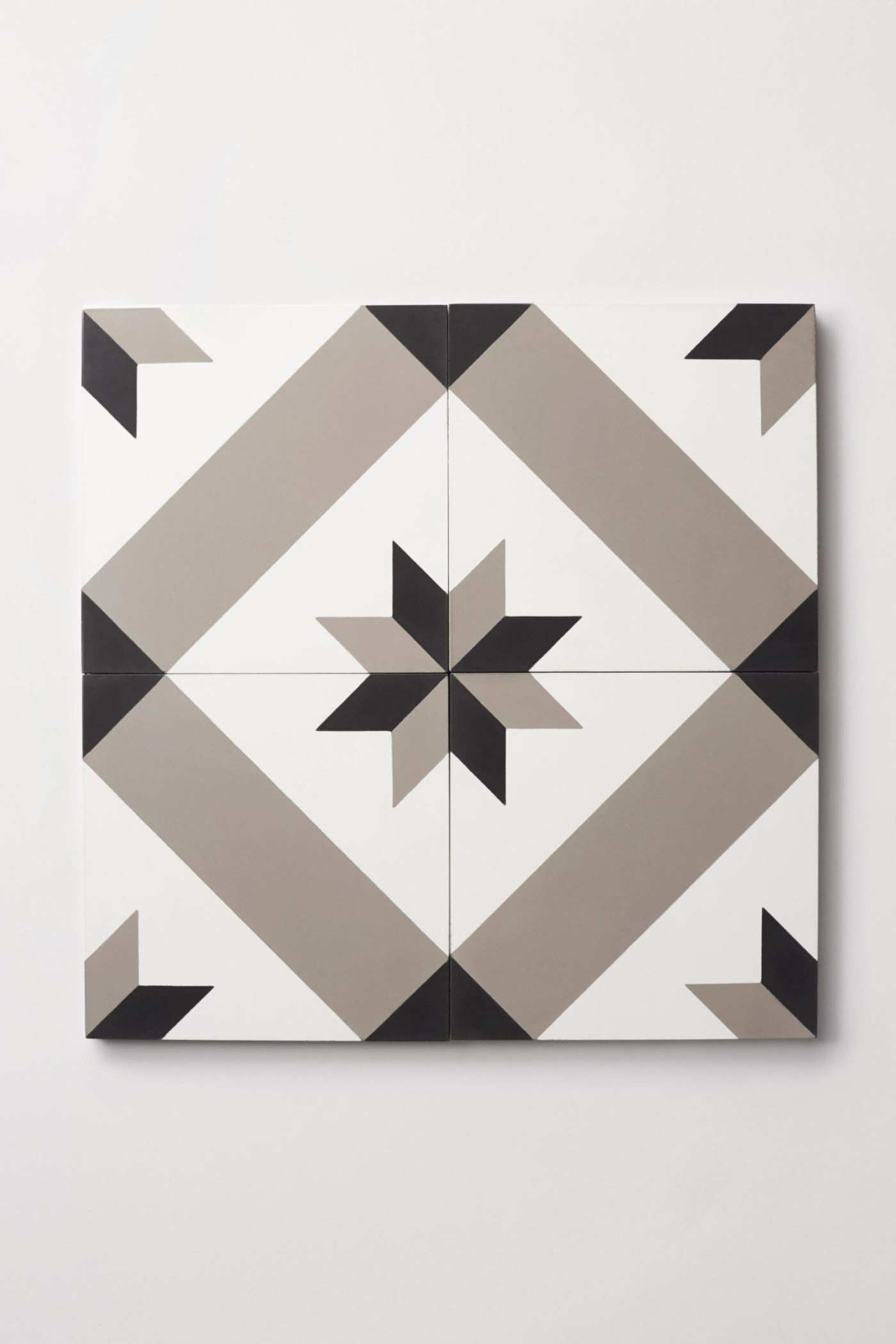 four tiles with a black and white designs forming a pattern.