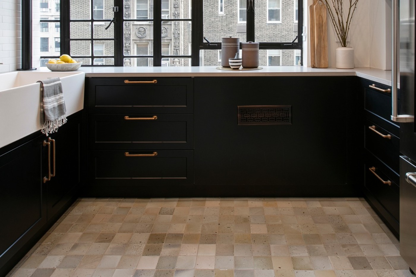 a kitchen with black cabinets and a window.