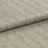Folded beige-and-brown woven fabric with diagonal herringbone ribs; folded over itself forming parallel raised ridges; close-up on a flat surface under soft, neutral lighting.