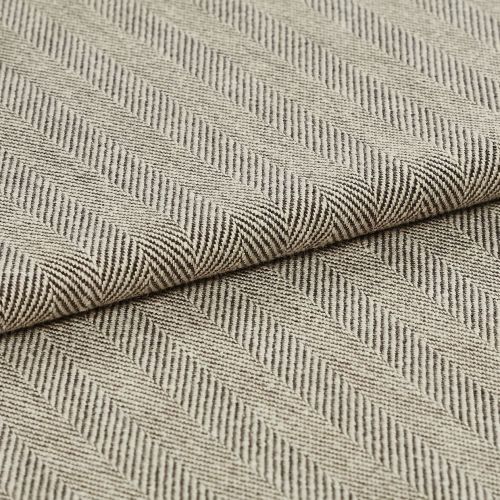 Folded beige-and-brown woven fabric with diagonal herringbone ribs; folded over itself forming parallel raised ridges; close-up on a flat surface under soft, neutral lighting.