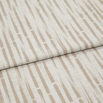 Beige-and-cream patterned textile (elongated dashes) folded across the center, overlapping slightly; close-up, even soft lighting on a flat surface, resembling upholstery or drapery material.