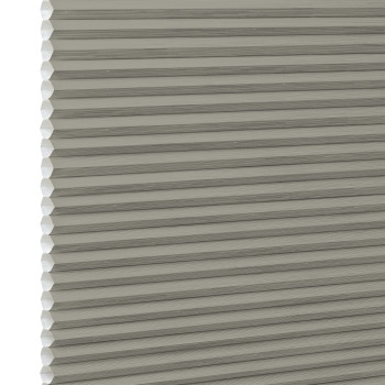 Gray-beige cellular honeycomb blind, pleated with visible hexagonal cell edges at left, closed and filtering light; close-up view with neutral, evenly diffused lighting and no visible room.