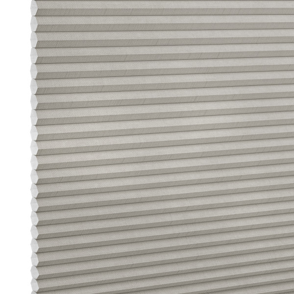 Light-gray pleated cellular window shade, closed with visible honeycomb cells and fabric texture; blocking light and insulating; shown close-up against a neutral, evenly lit backdrop.