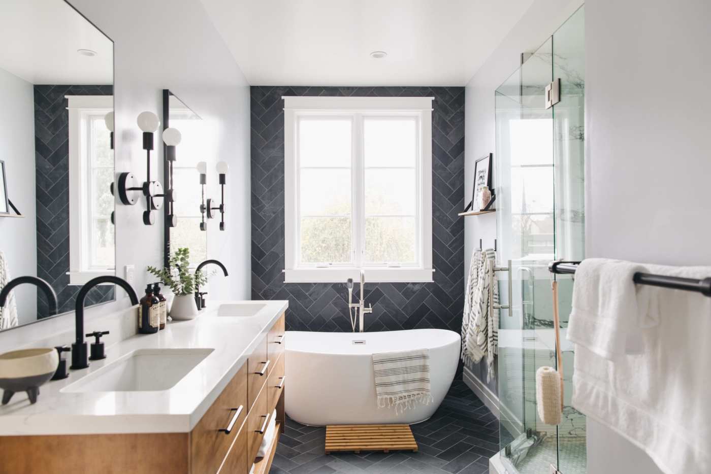 a black and white bathroom with a tub and sink.