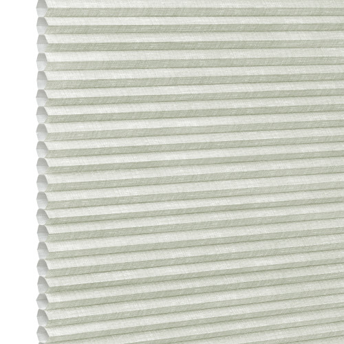 Pale green honeycomb (cellular) blind, fully lowered with visible hexagonal cells and textured fabric; closed, gently diffusing daylight; fills the frame against a bright neutral background suggesting an interior window.