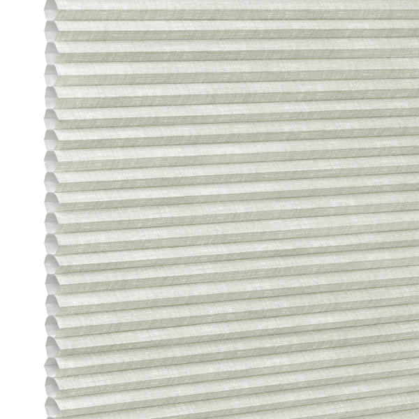 Pale green honeycomb (cellular) blind, fully lowered with visible hexagonal cells and textured fabric; closed, gently diffusing daylight; fills the frame against a bright neutral background suggesting an interior window.
