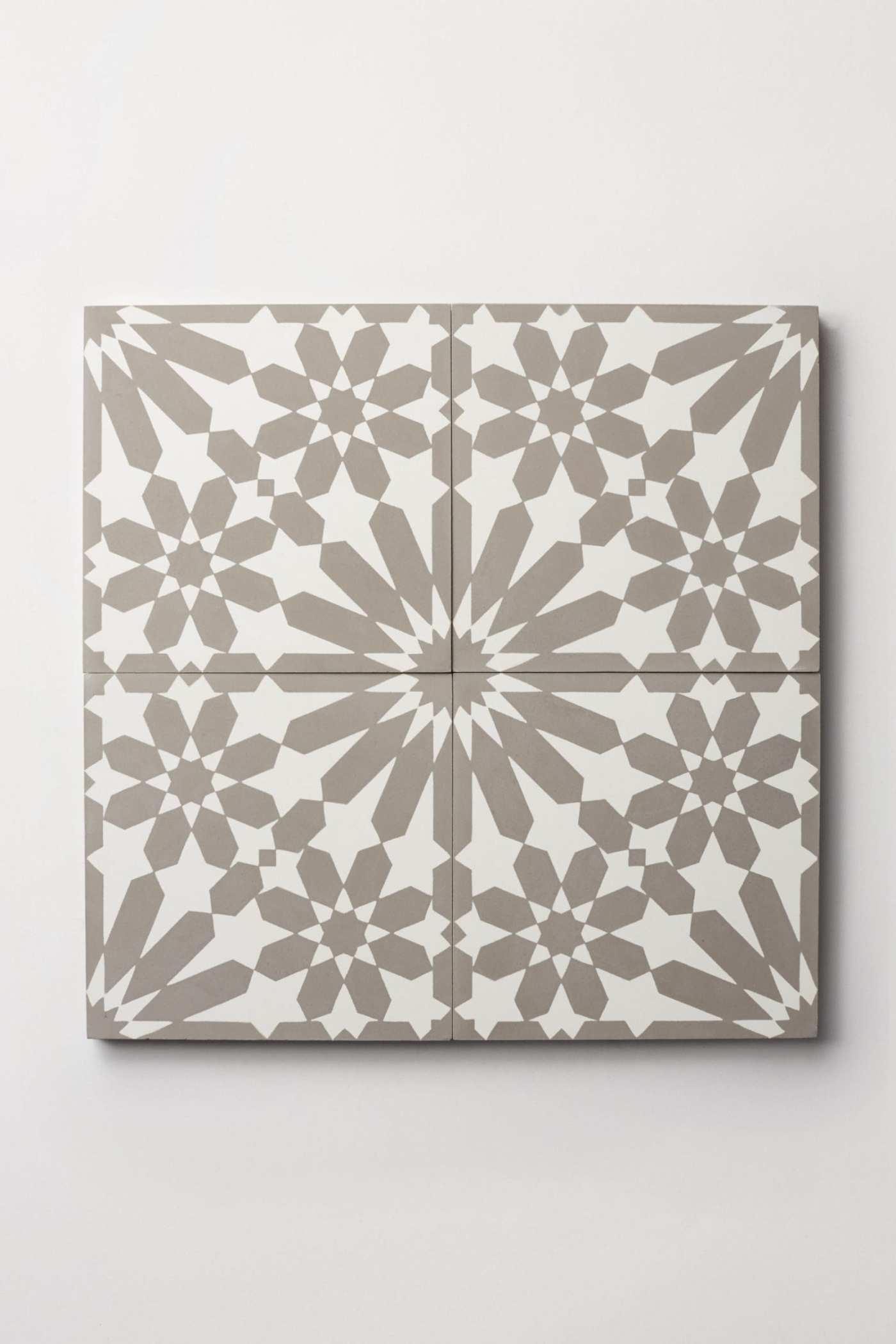 four grey and white tiles forming an ornate pattern.