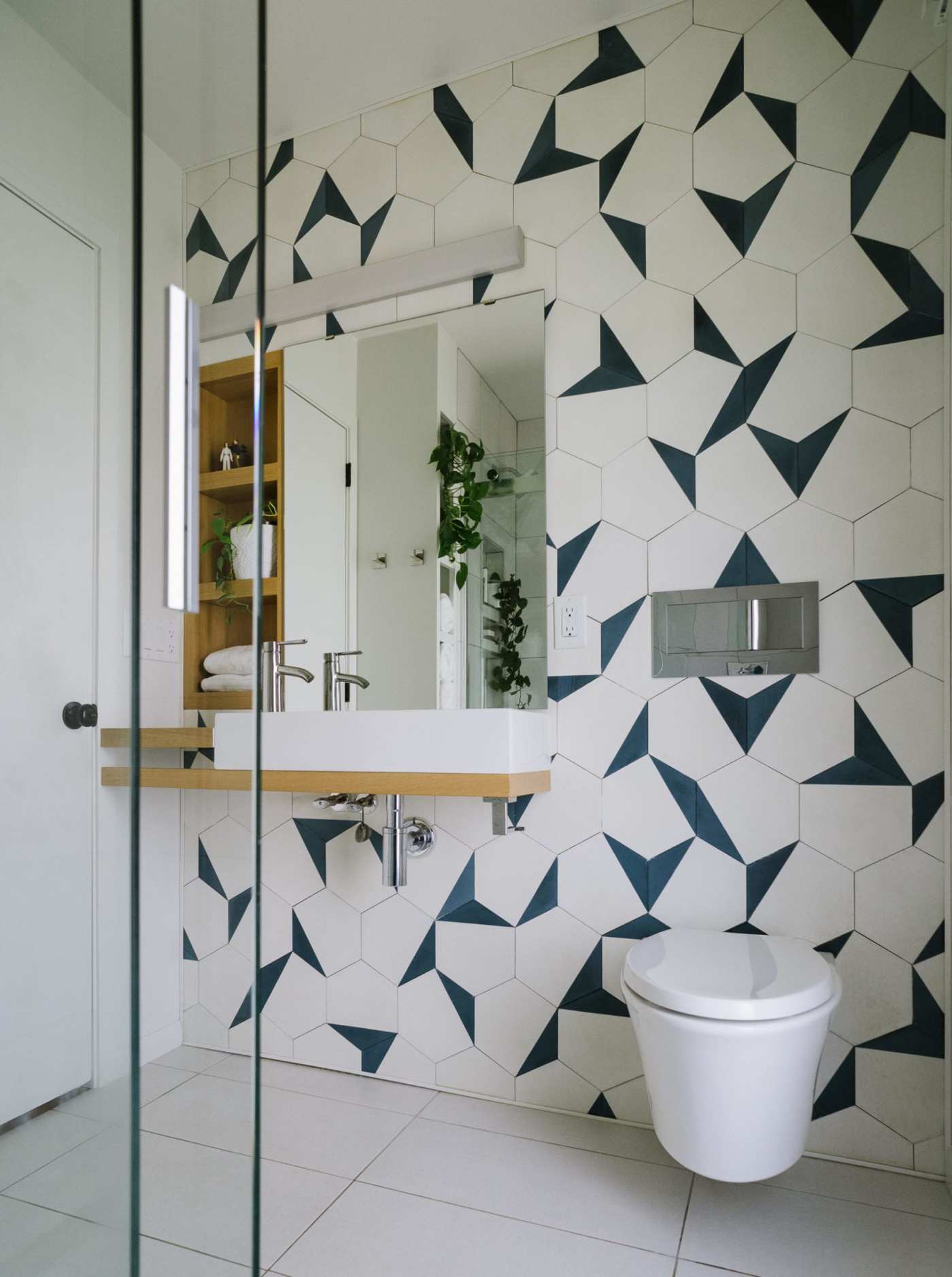 a bathroom with blue and white geometric tiles.