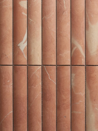 a close up of a row of red marble tiles.