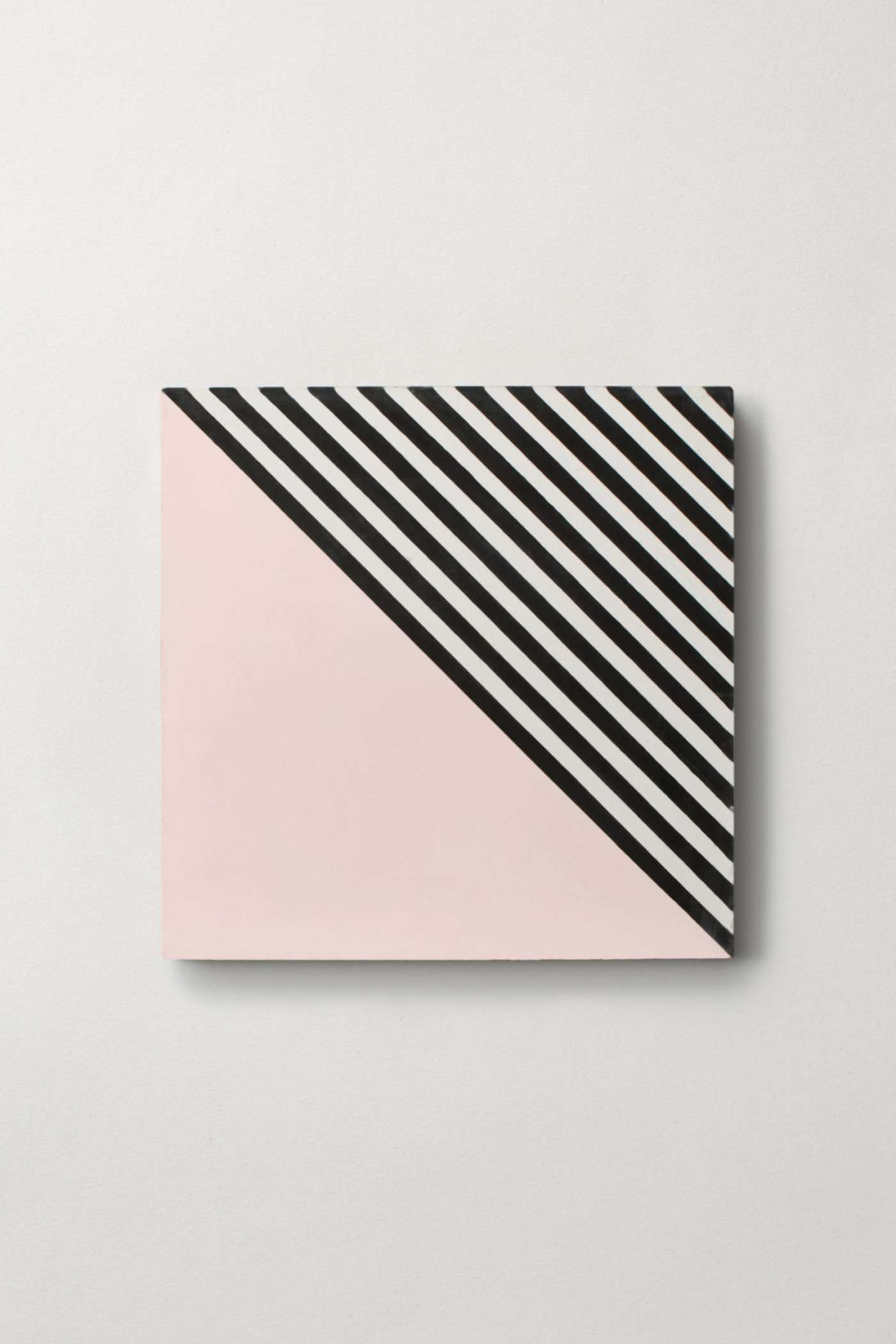 a pink and black striped tile on a white background.