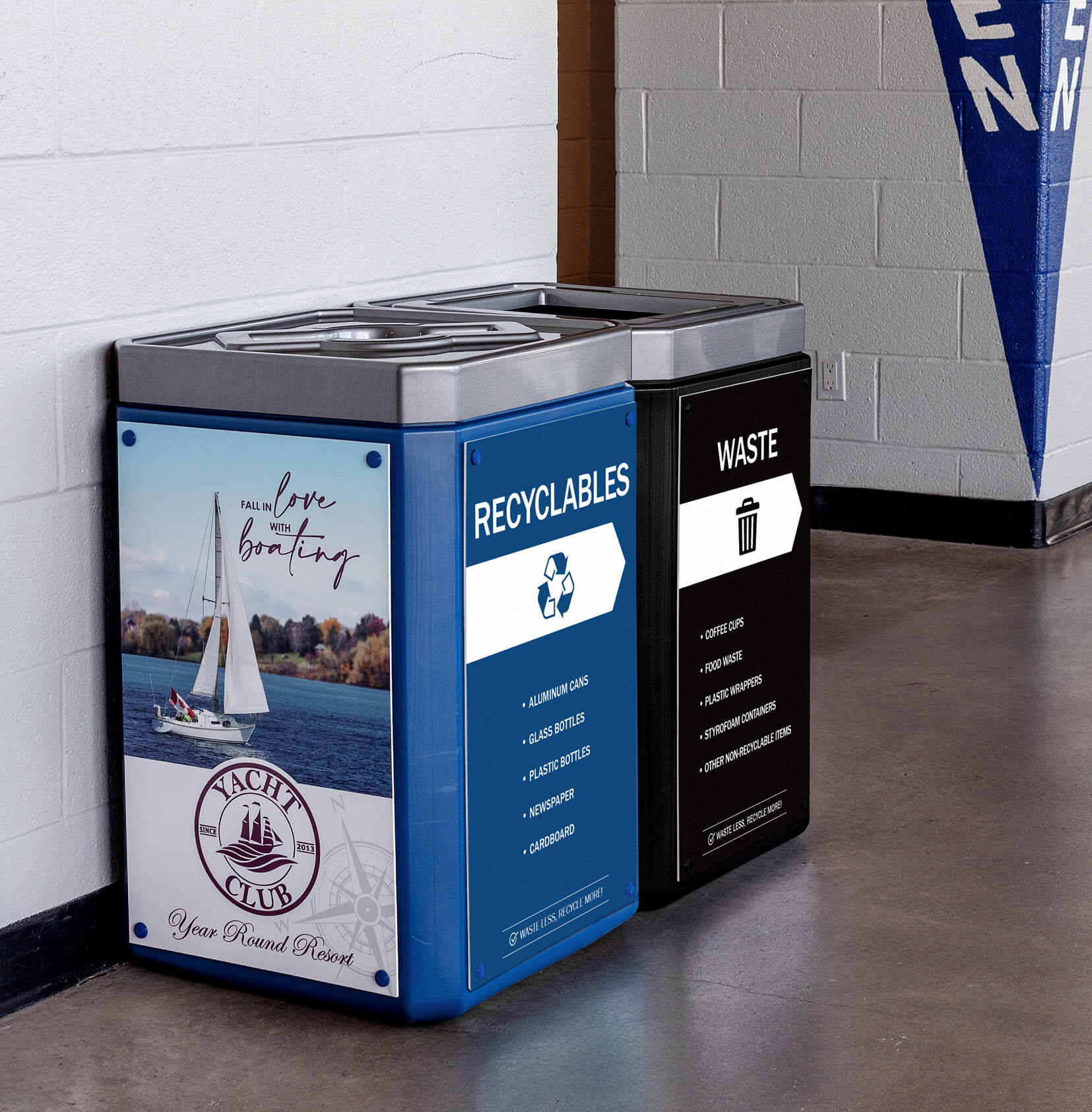 double recyclables and waste large capacity plastic containers inside a hockey arena also including body signs for collection and advertising
