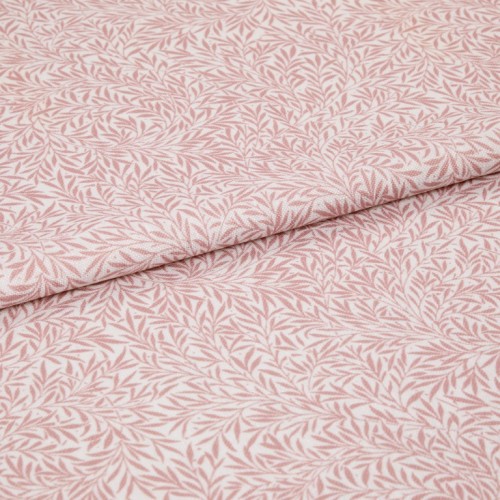 Pink-and-white patterned fabric (leaf print) folded in half and overlapping; close-up flat lay on a neutral surface with soft, even lighting, highlighting woven texture and repeating botanical motif.
