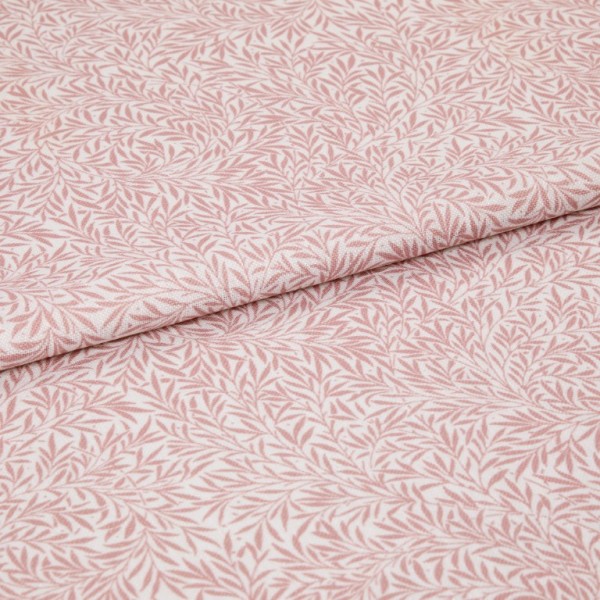 Pink-and-white patterned fabric (leaf print) folded in half and overlapping; close-up flat lay on a neutral surface with soft, even lighting, highlighting woven texture and repeating botanical motif.