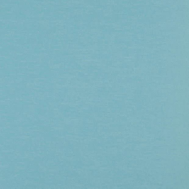 Light blue textured fabric or painted wall filling the frame; lying flat and evenly lit; diffuse daylight ambience with no visible objects, depth cues, or distinct features.