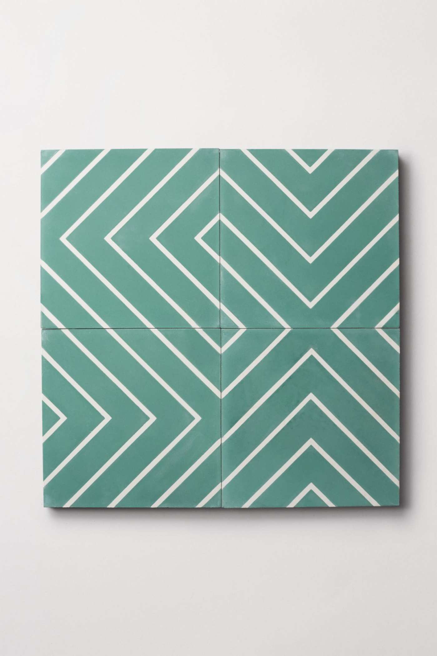 four teal and white tiles forming a chevron pattern.