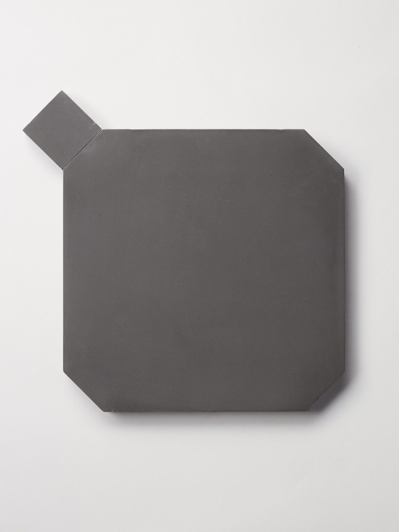 a black octagonal tile next to a smaller square black tile.