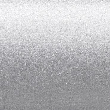 Silver metallic textured surface occupying the frame, scattering diffuse light with a subtle horizontal gradient; a flat, finely granulated panel in a neutral, evenly lit background.