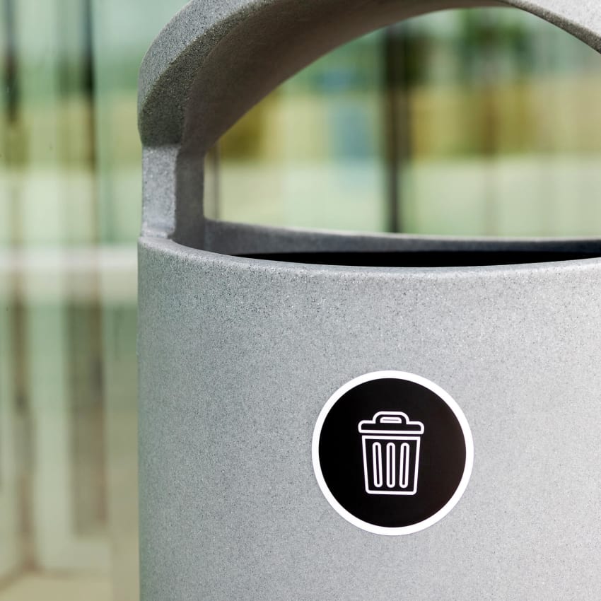 close up of grey trash container showing canopy lid and body label