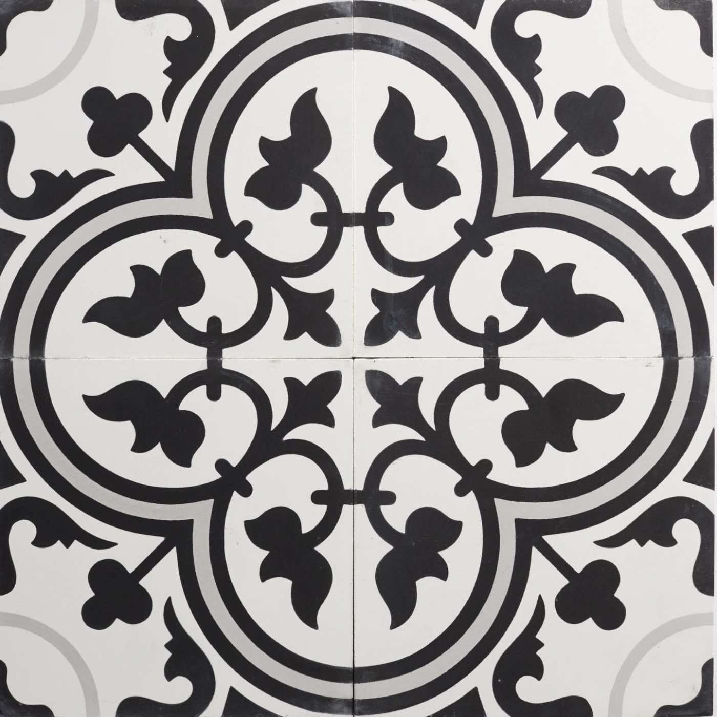 four black and white tiles with ornate designs.