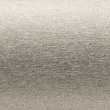 Brushed metal panel with fine horizontal grain; surface displays subtle sheen and faint gradient, reflecting soft diffuse light; close-up, neutral plain background with even studio lighting.