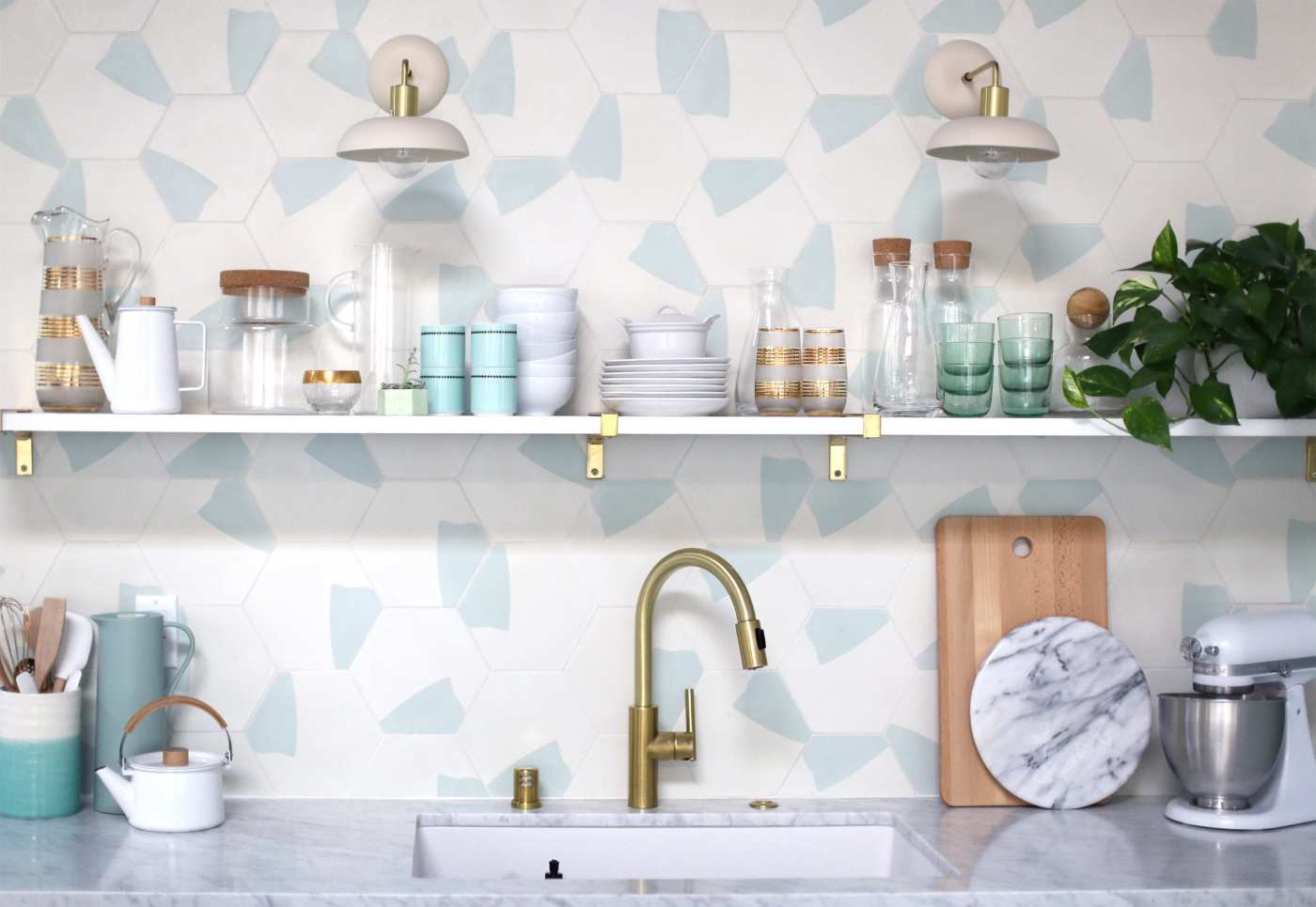 a kitchen with a blue and white tiled sink backsplash.