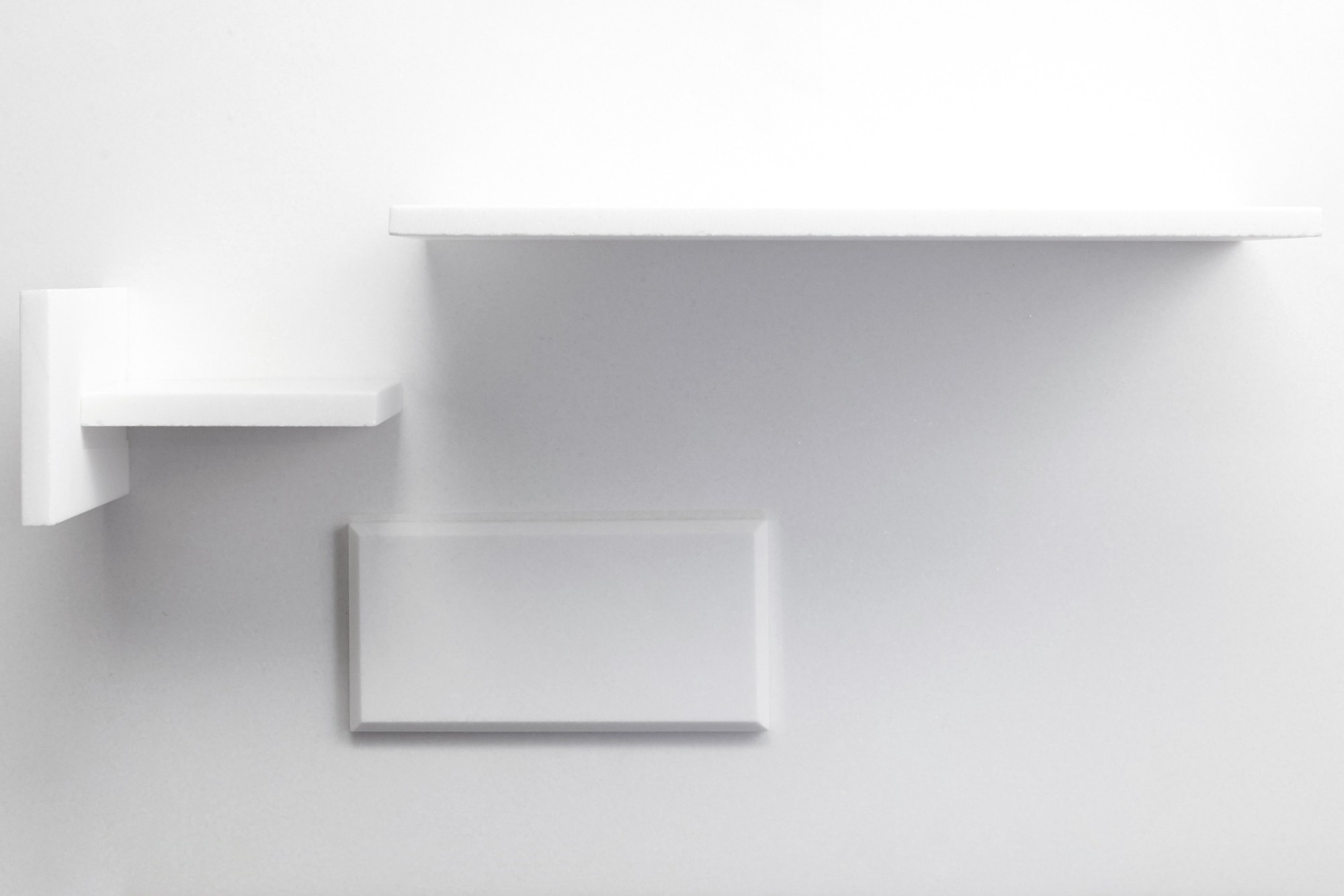 a white shelf on a white wall.