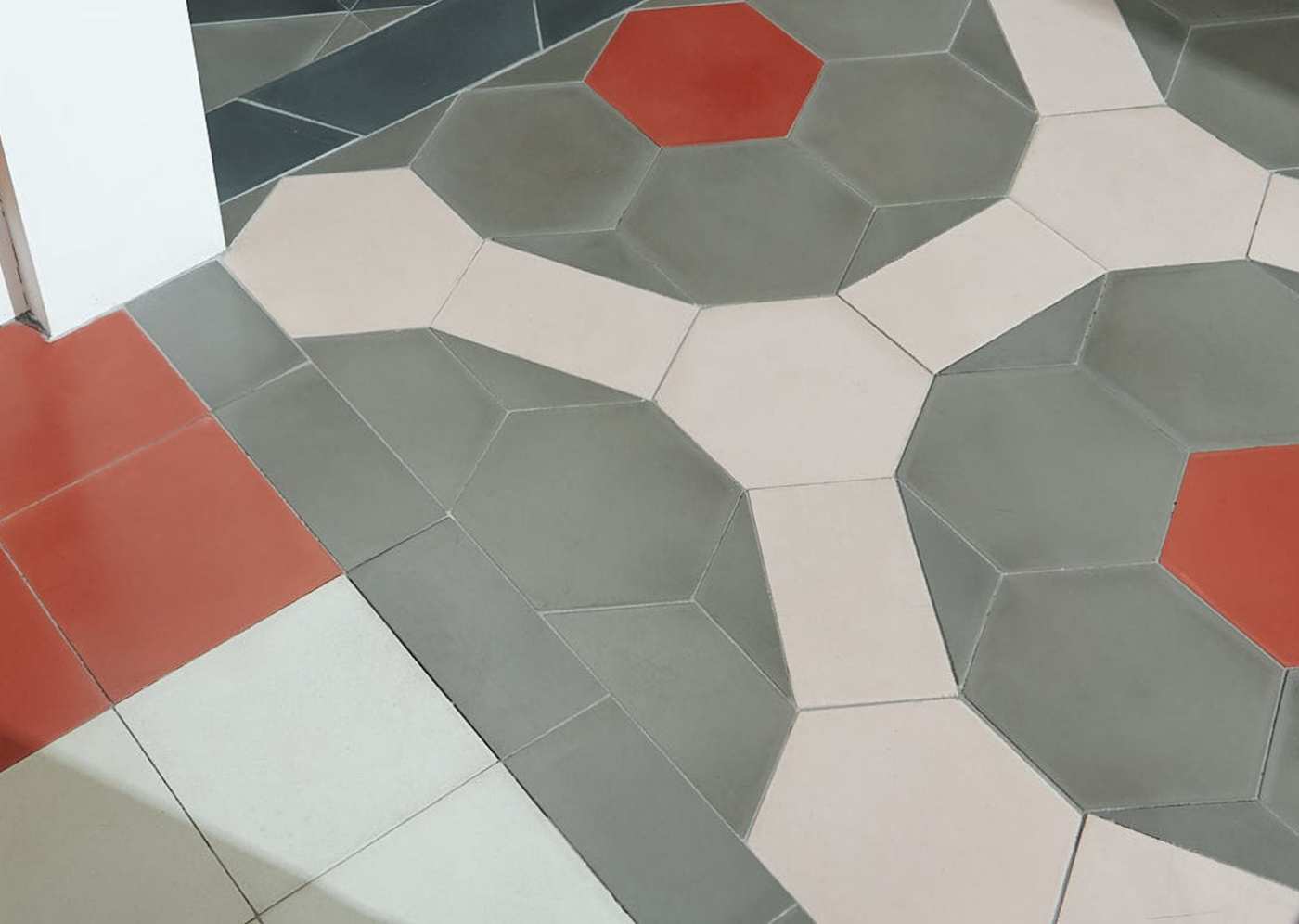 a tiled floor with red, orange, and grey tiles.