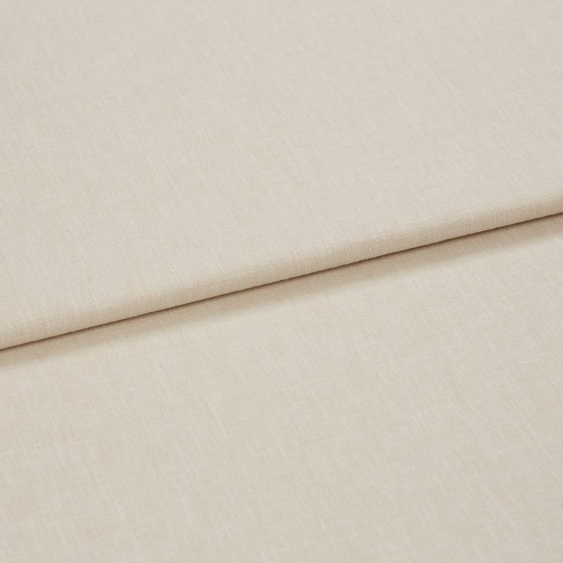 Beige woven curtain-like fabric panel with a clean horizontal fold (overlapping layer); lying flat on a neutral surface; close-up, soft diffuse lighting.