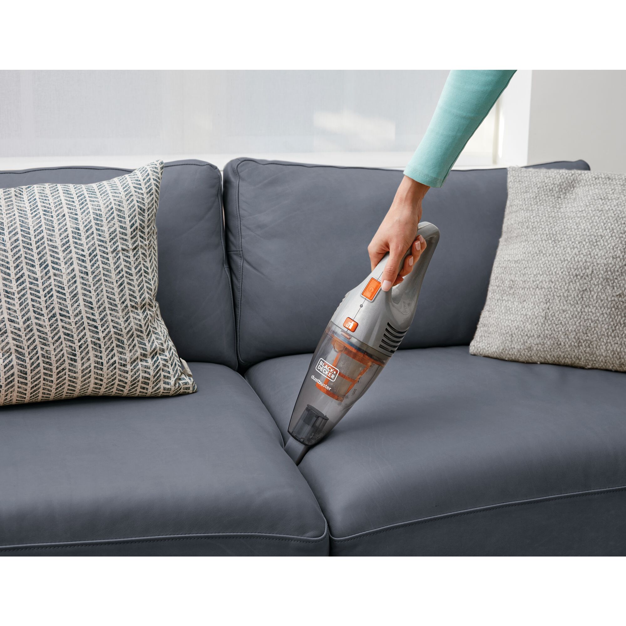 POWER SERIES 2 in 1 Cordless Stick Vacuum being used in between sofa cushions.