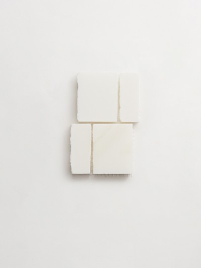 a white square of soap on a white surface.