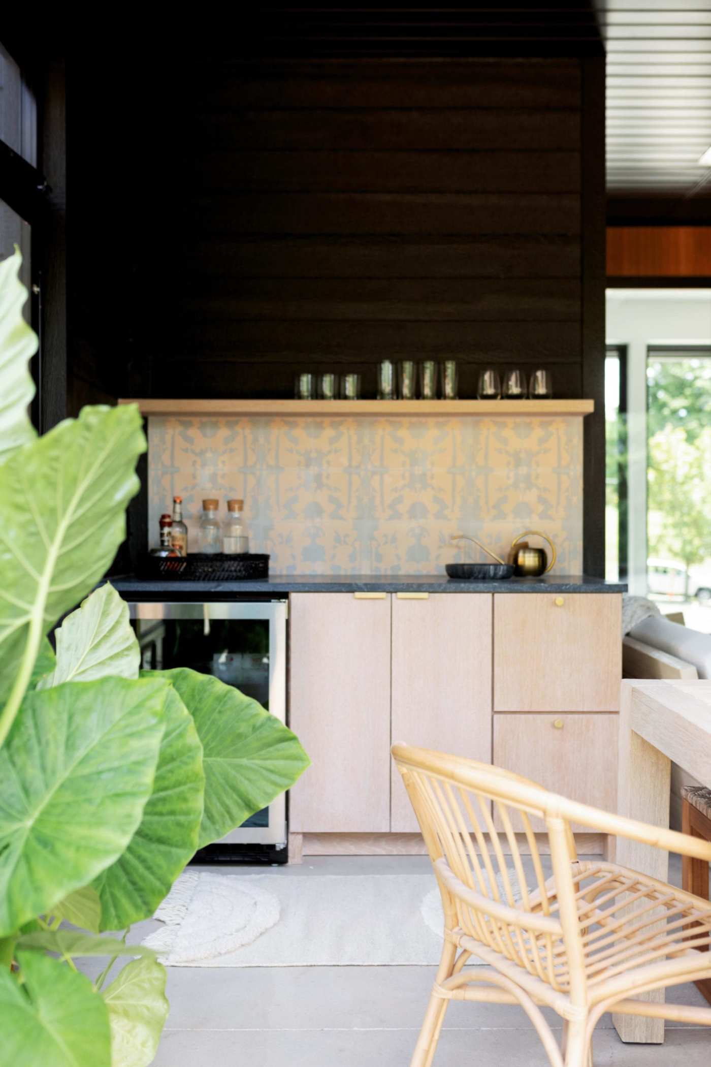 a kitchen with a table and chairs and a plant.