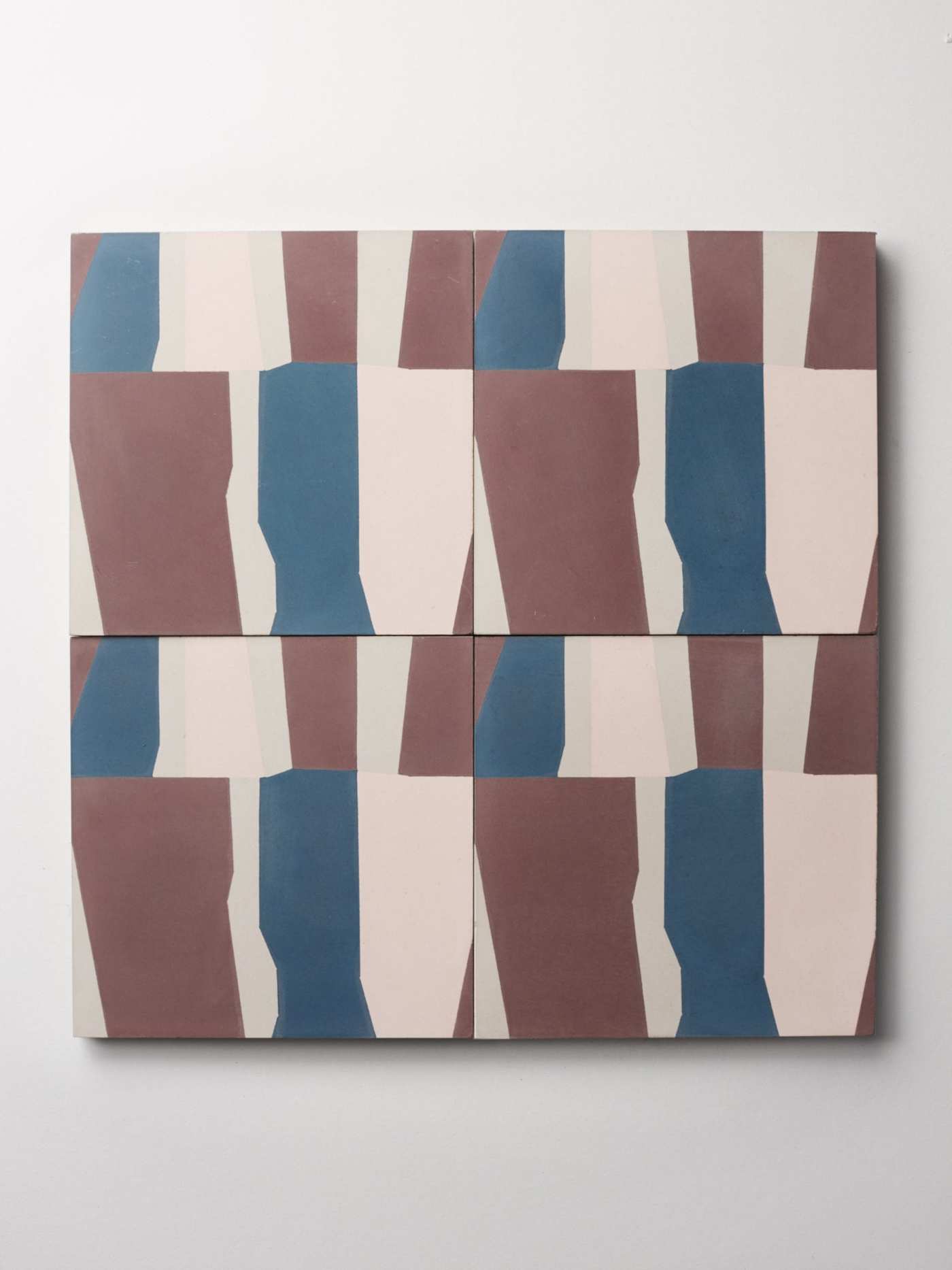 four blue, pink, and brown tiles on a white surface.