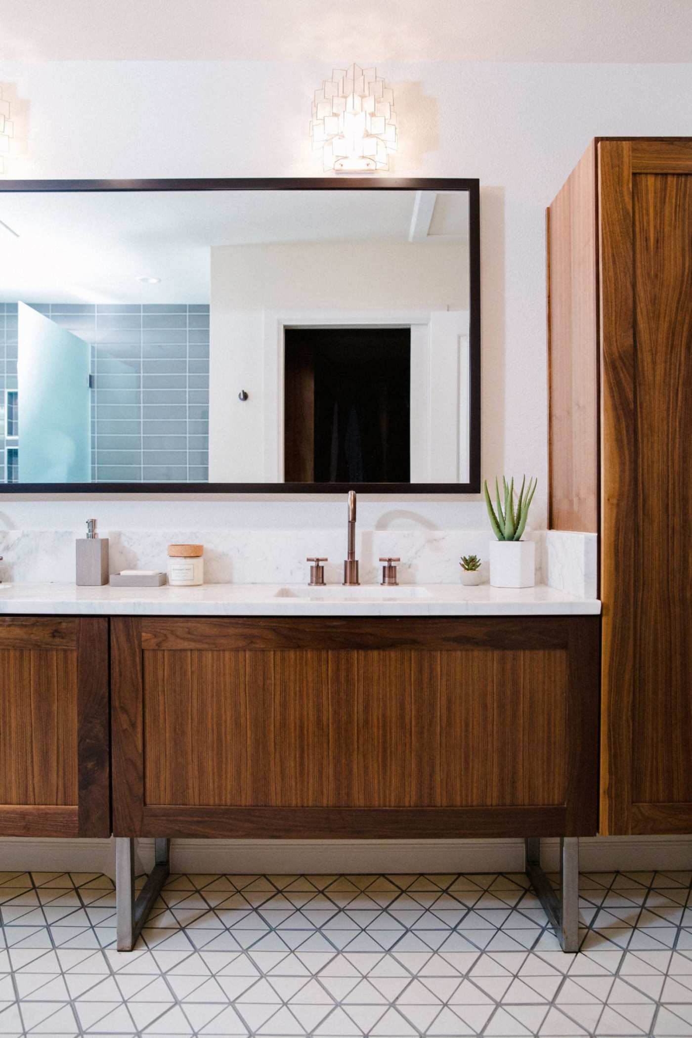 a bathroom with wooden cabinets and a mirror.