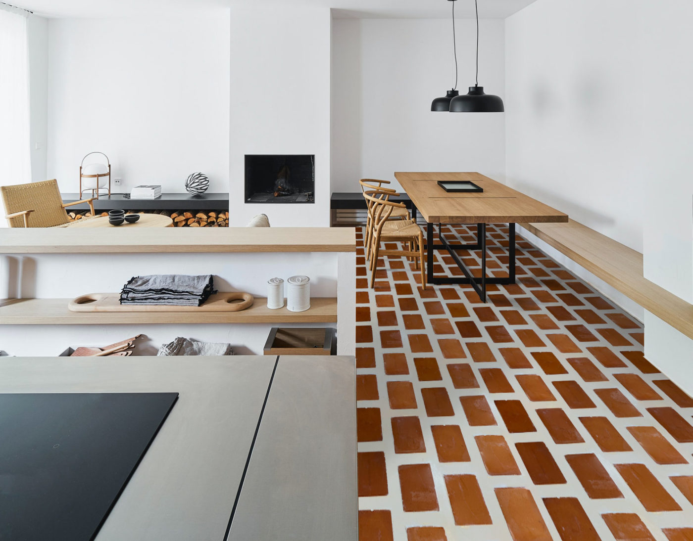 a kitchen with a red brick tiled floor