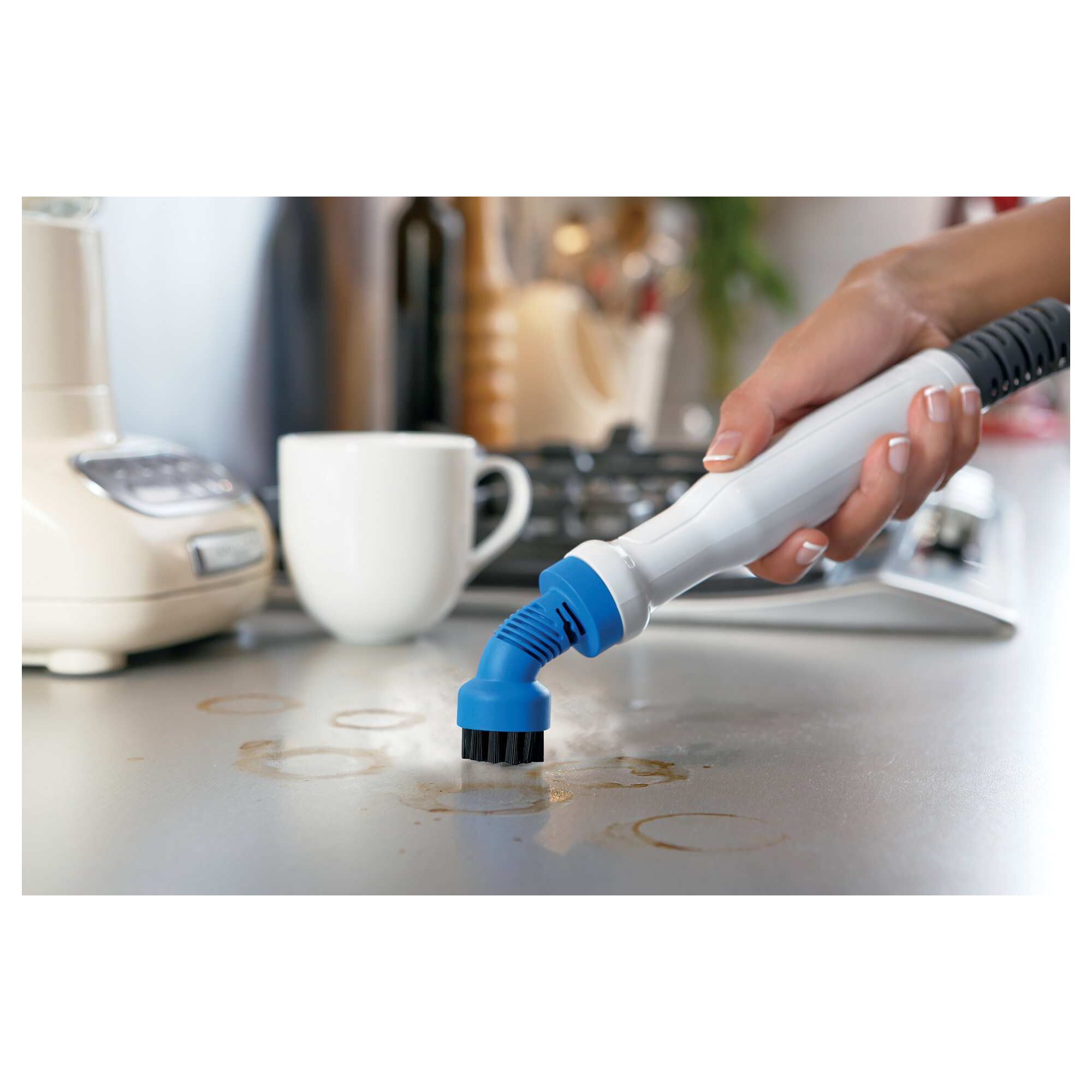 8 in 1 Complete Steam Cleaning System being used to clean stains on a table.
