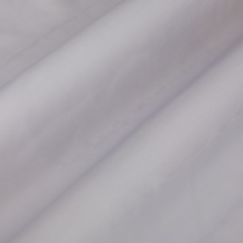 Pale lavender curtain fabric, hanging in soft diagonal folds, gently diffusing light in a neutral, dim interior close-up.