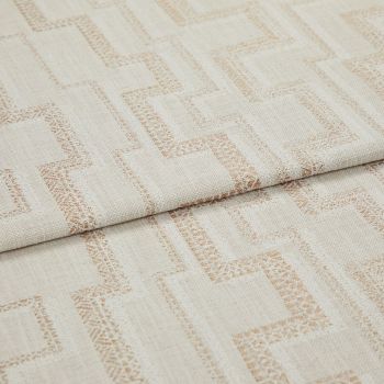 Beige woven fabric with light-brown geometric square pattern (curtain/upholstery fabric) folded over itself, revealing textured weave; close-up studio product view under soft, neutral lighting.