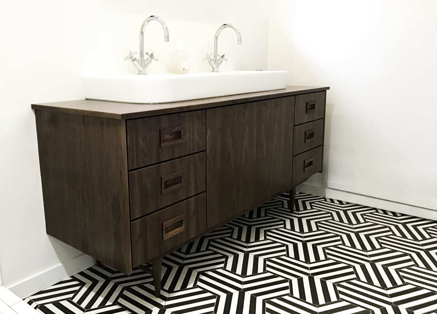 a bathroom with a black and white tile floor.