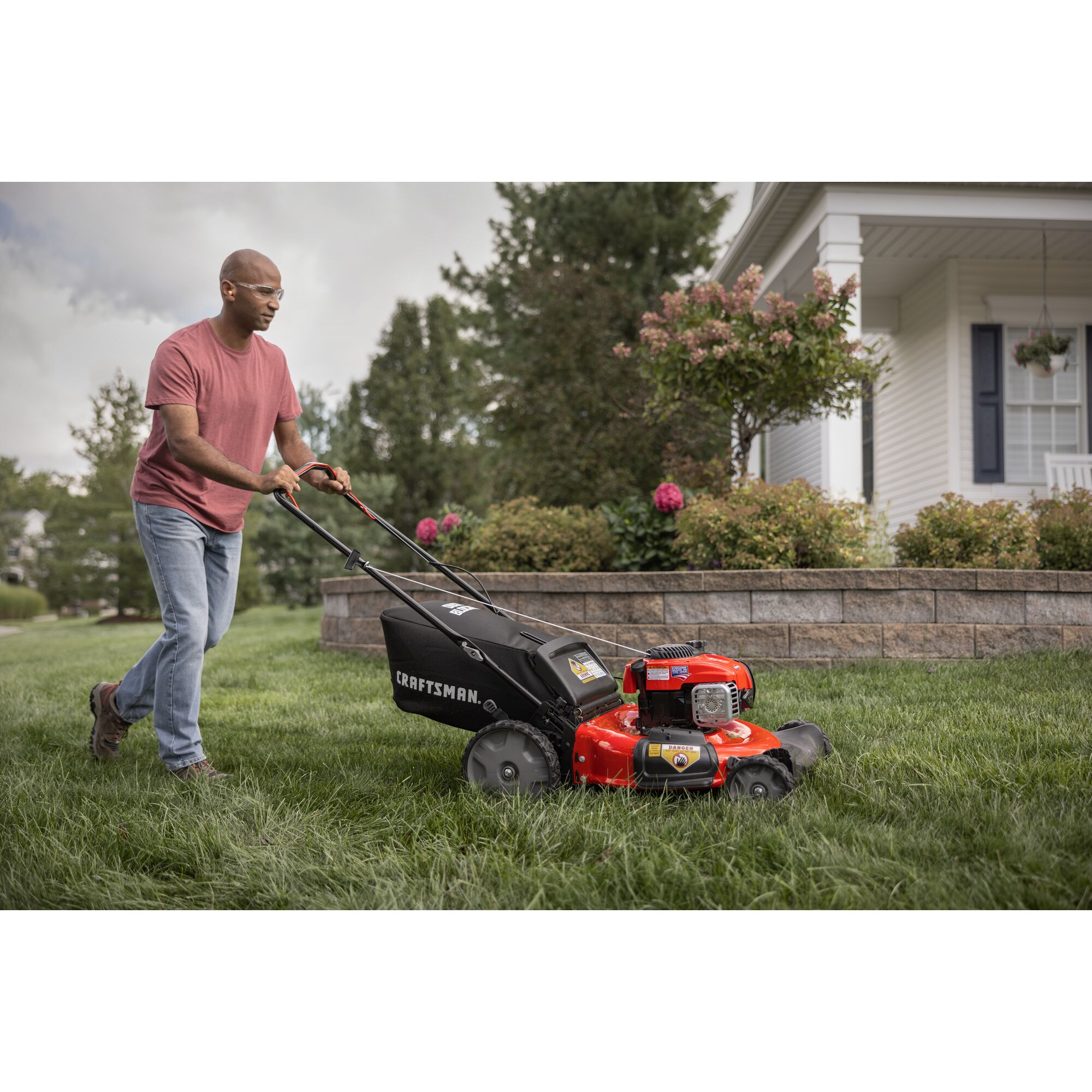 CRAFTSMAN 21-in 150cc Gas Push Mower mowing yard in front of house