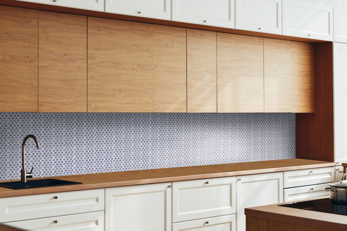 a kitchen with a blue and wgute tiled backsplash.